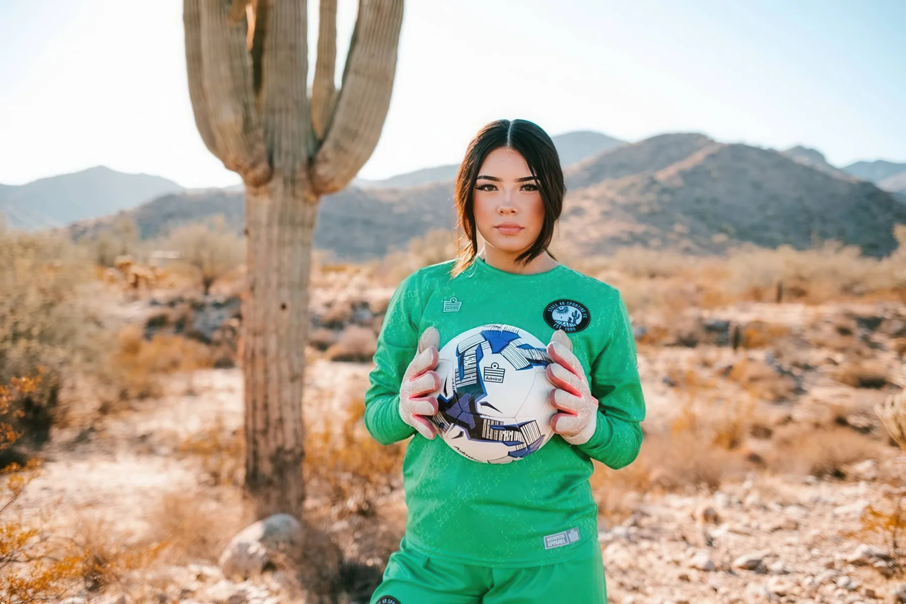 State 48 goalkeeper wearing the green goalkeeper kit in the desert